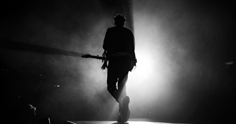 silhouette photo of man playing the guitar