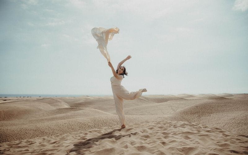 Woman in a desert posing is emerging artist Naheli from the Artist Development roster.