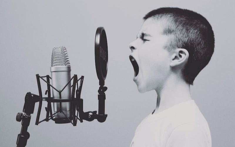 boy singing into microphone