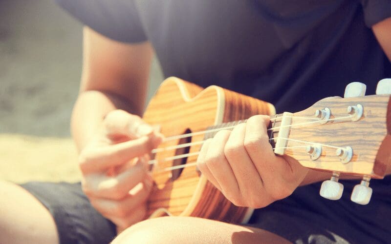 boy playing ukulele