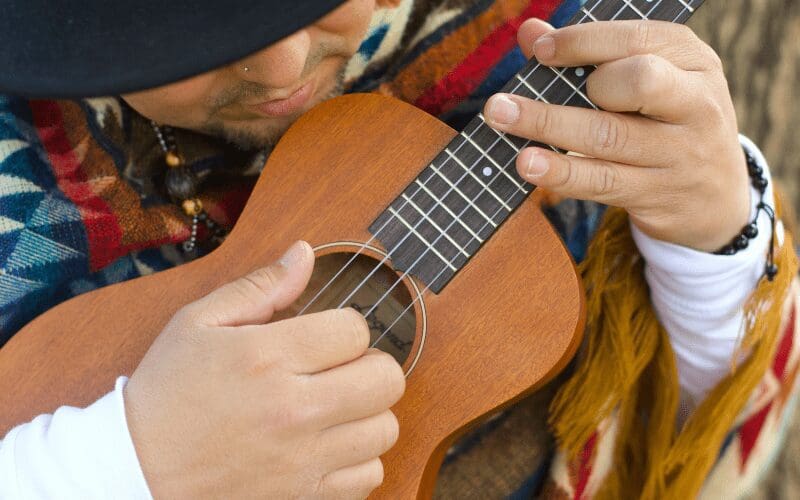 man playing ukulele chords
