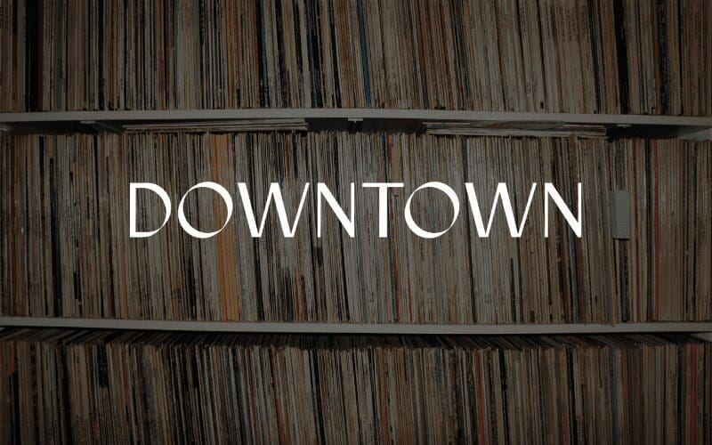 Downtown music publishing logo with vinyls in the back.