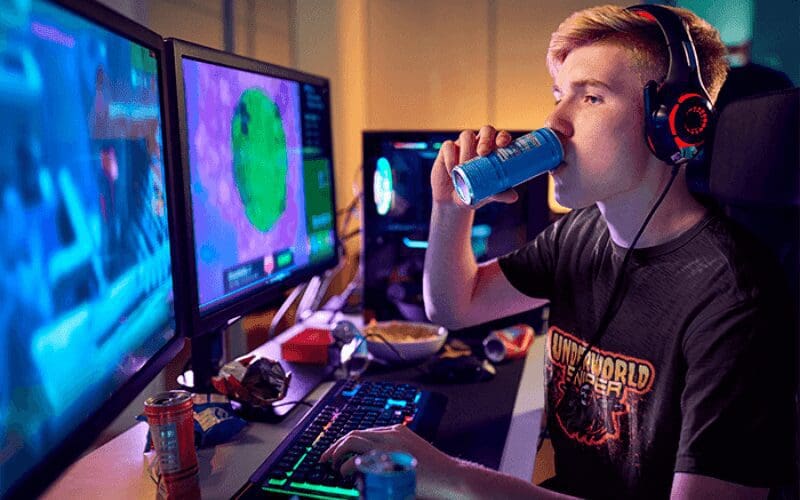 gamer drinking energy drink while playing