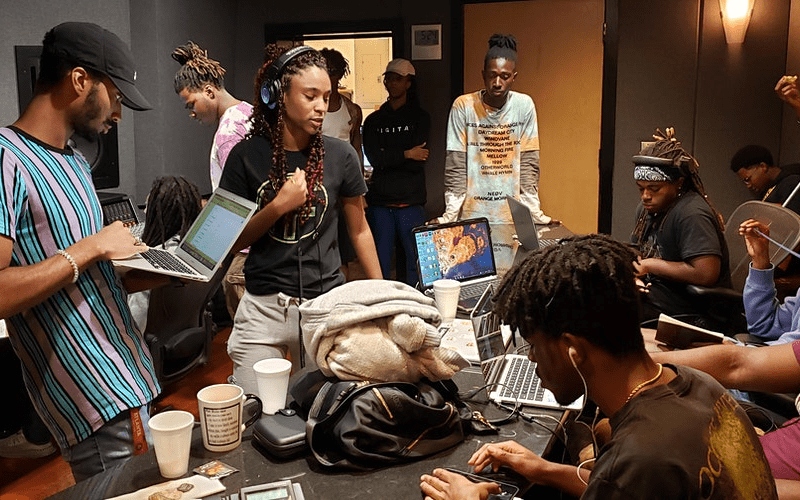 artists in a recording studio sending demo to record label
