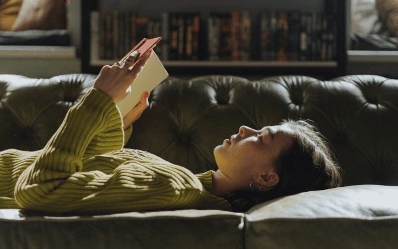 girl reading a book lying down