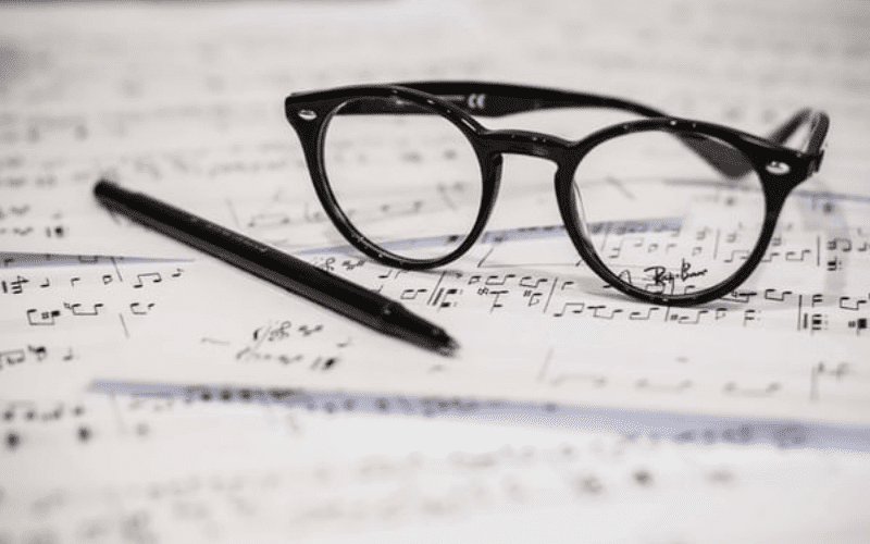 glasses and pen on sheet music