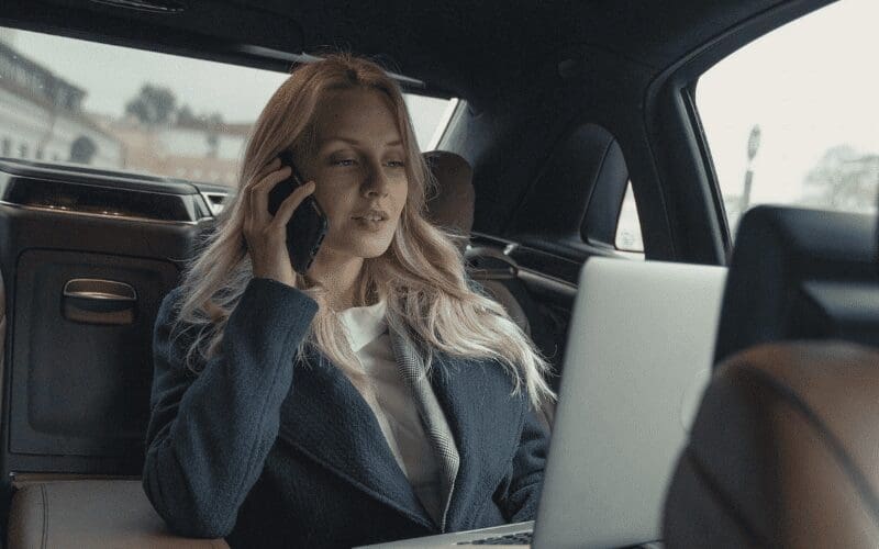 manager in a car on the phone 