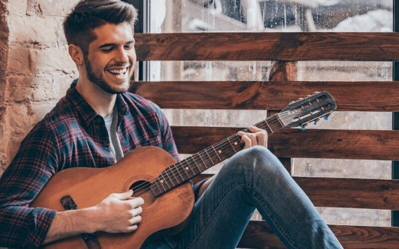 musician playing and smiling