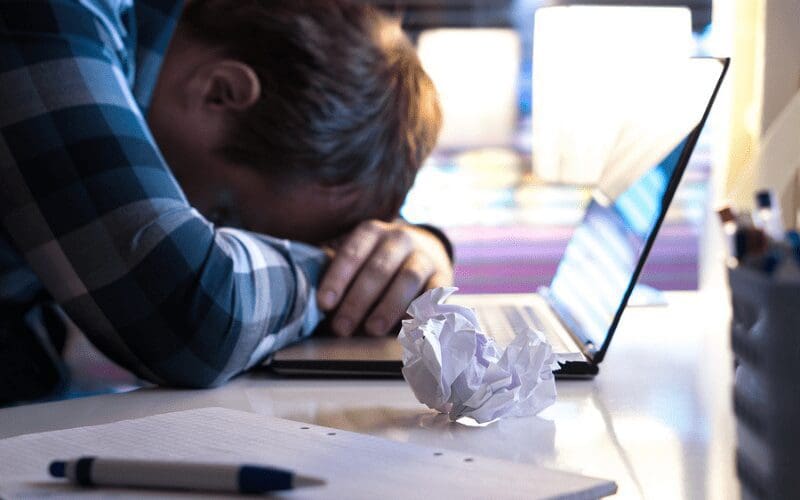 writers block laptop at desk frustration