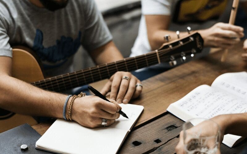 guitar player musicians writing music 