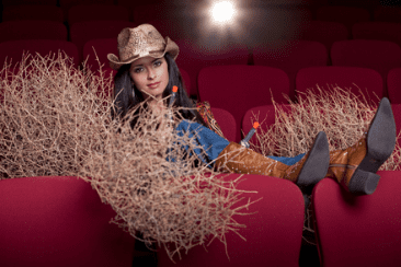 Woman dressed as cowgirl in cinema