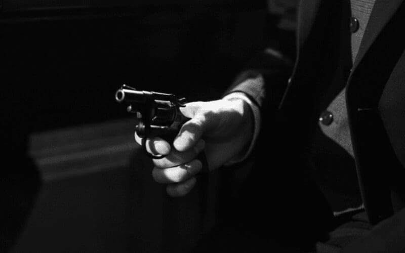 A spy movie protagonist holding a pistol