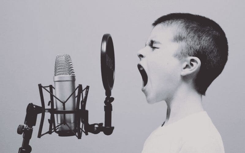 child singing into microphone 