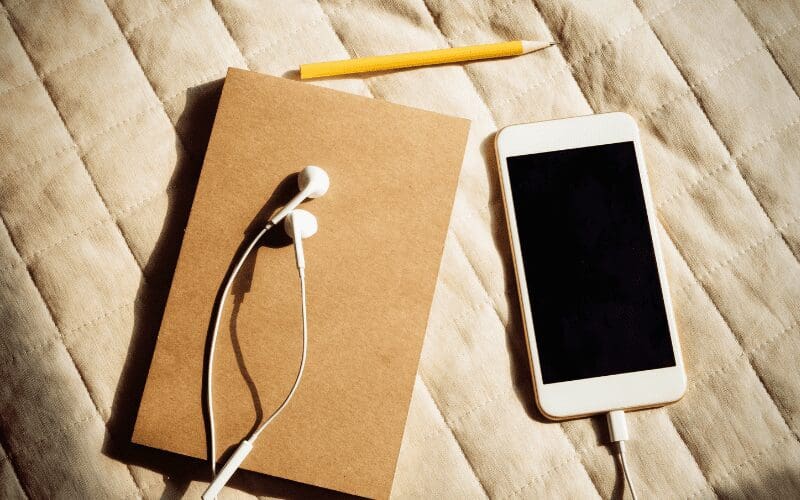 phone headphones and notebook 