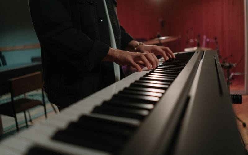 man playing the keyboard piano