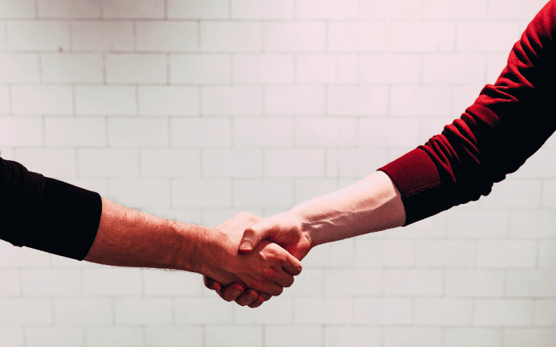music managers shaking hands