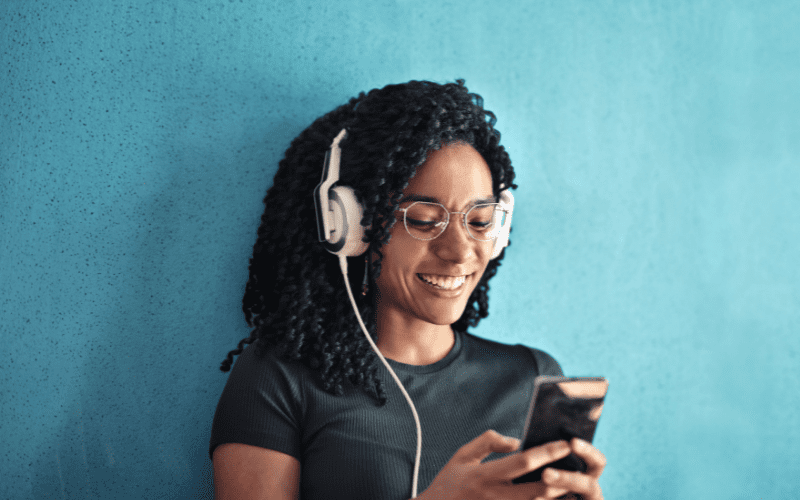 A woman listening to music through headphones