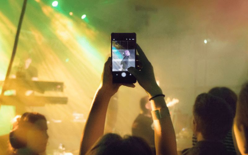 A person live streaming a concert